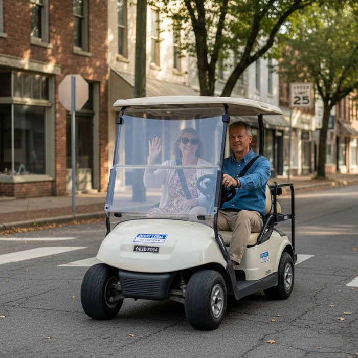 Couple driving golf cart on small-town street