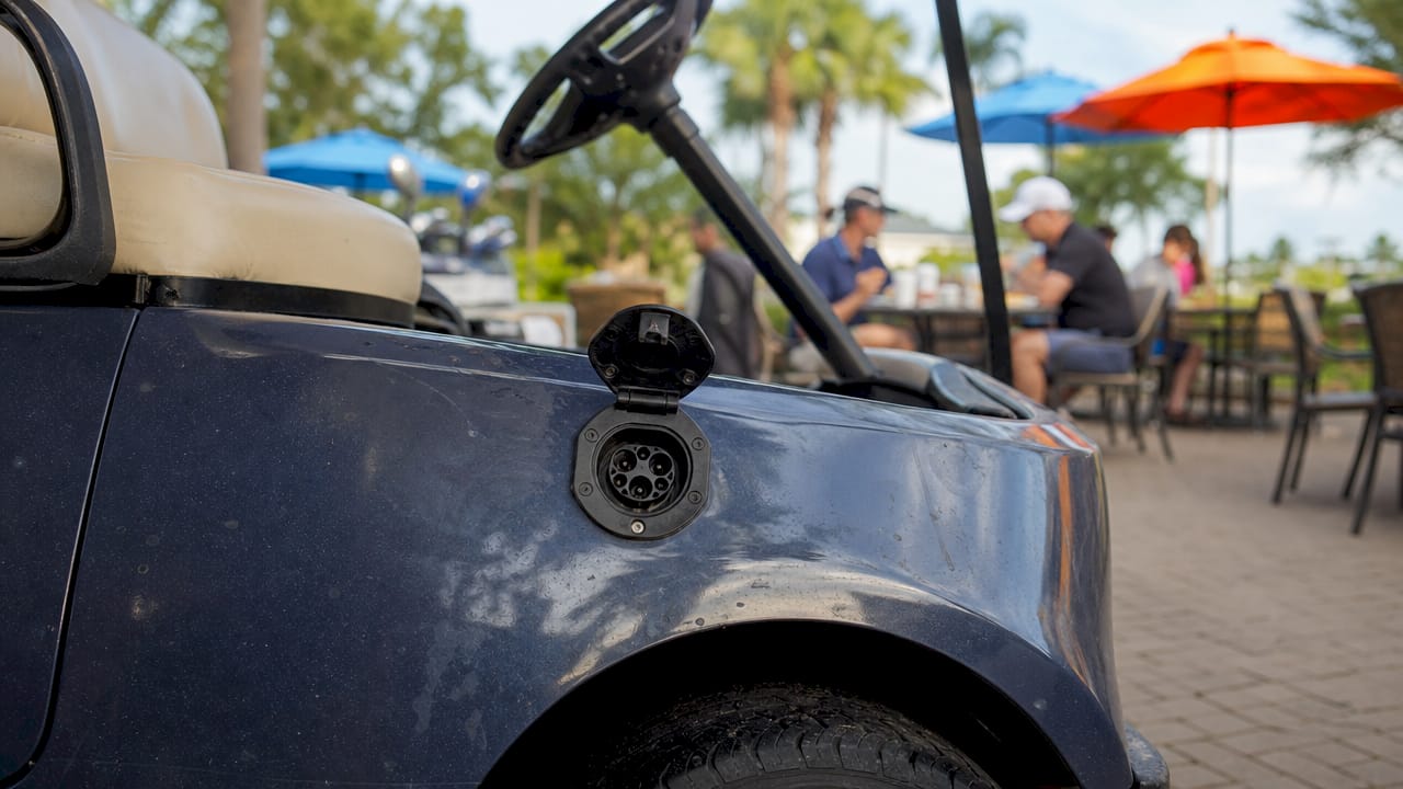 Golf cart charger port on driver-side panel