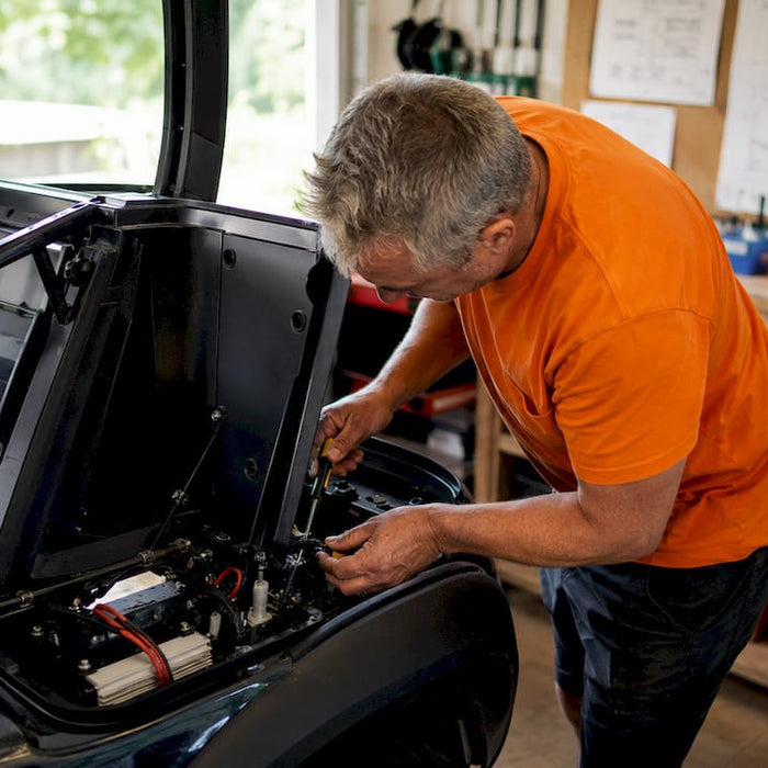 Technician repairing golf cart micro switch