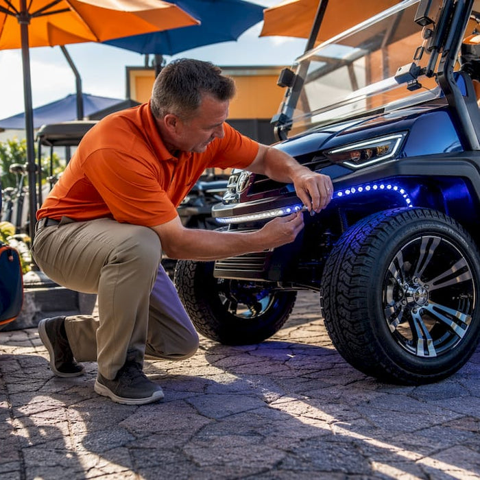 Dealer arranging golf cart accessories in showroom