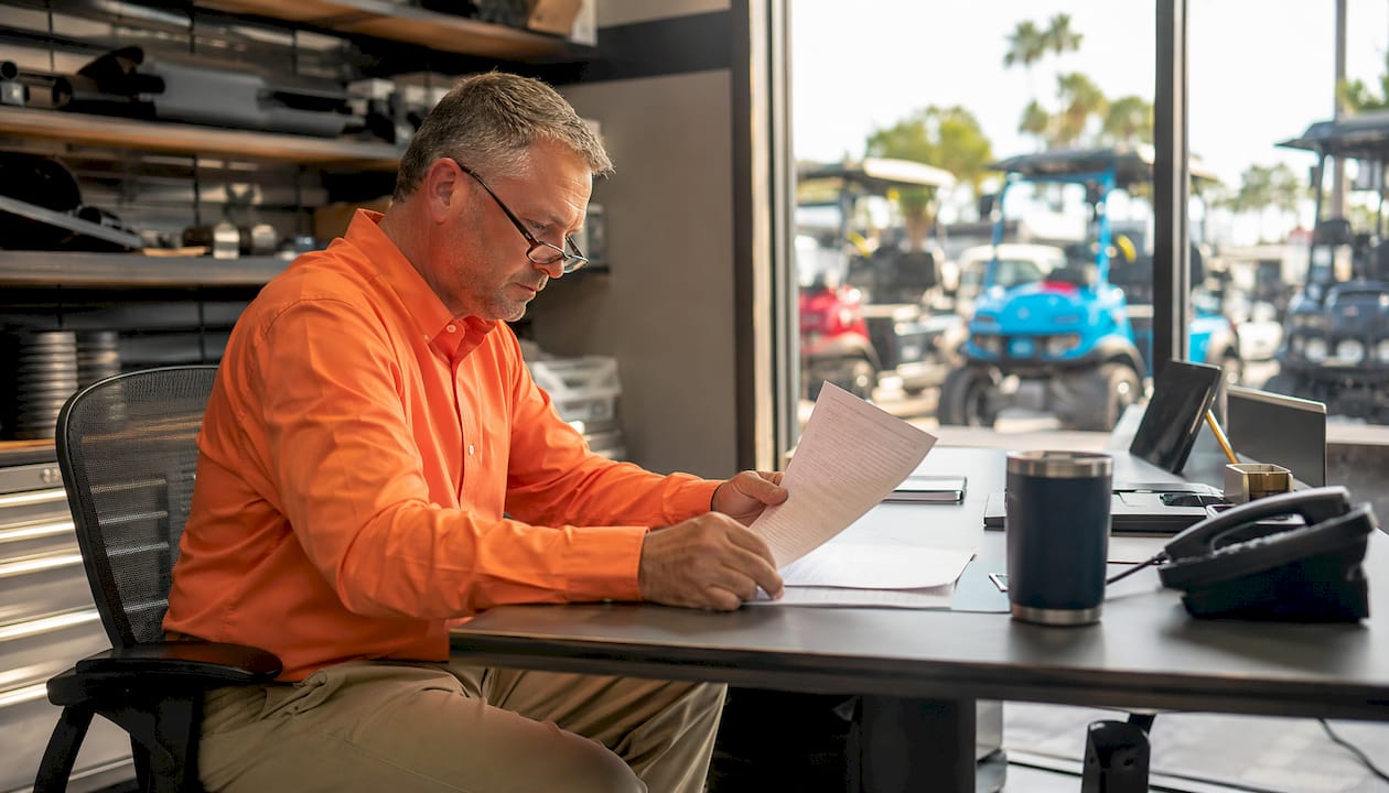 Dealer reviewing golf cart pricing policy
