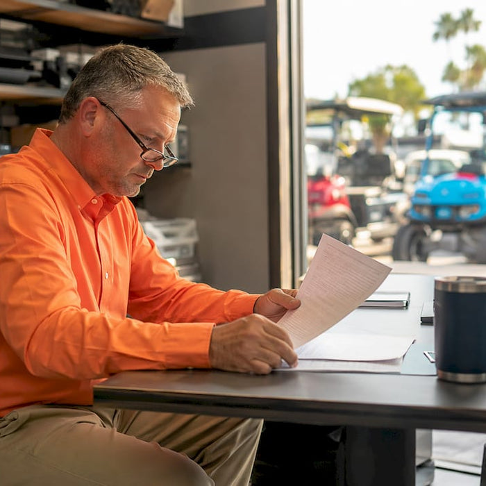 Dealer reviewing golf cart pricing policy