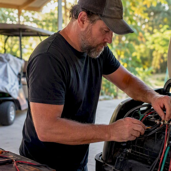 Technician wiring golf cart motor terminals