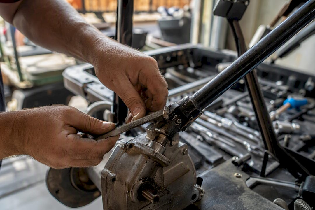 Hands marking golf cart steering shaft