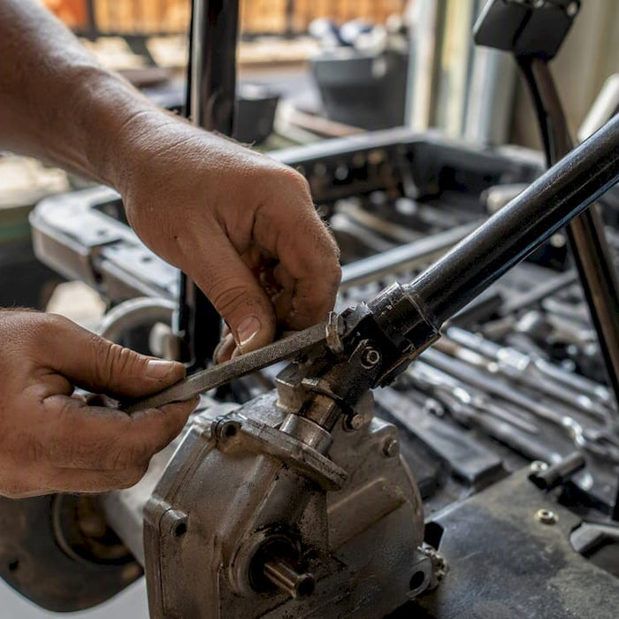 Hands marking golf cart steering shaft