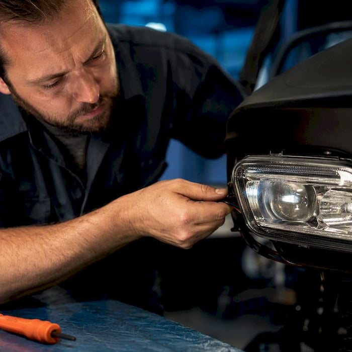 Technician inspecting golf cart headlight wiring