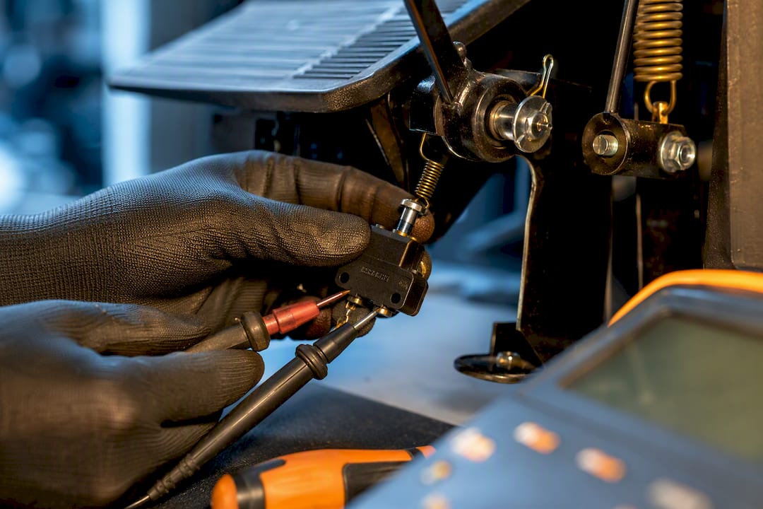 Technician testing a golf cart brake switch