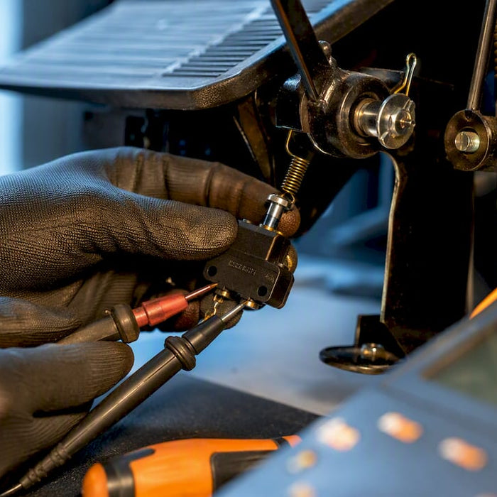 Technician testing a golf cart brake switch
