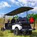 Golf cart with a canopy in a grassy outdoor setting