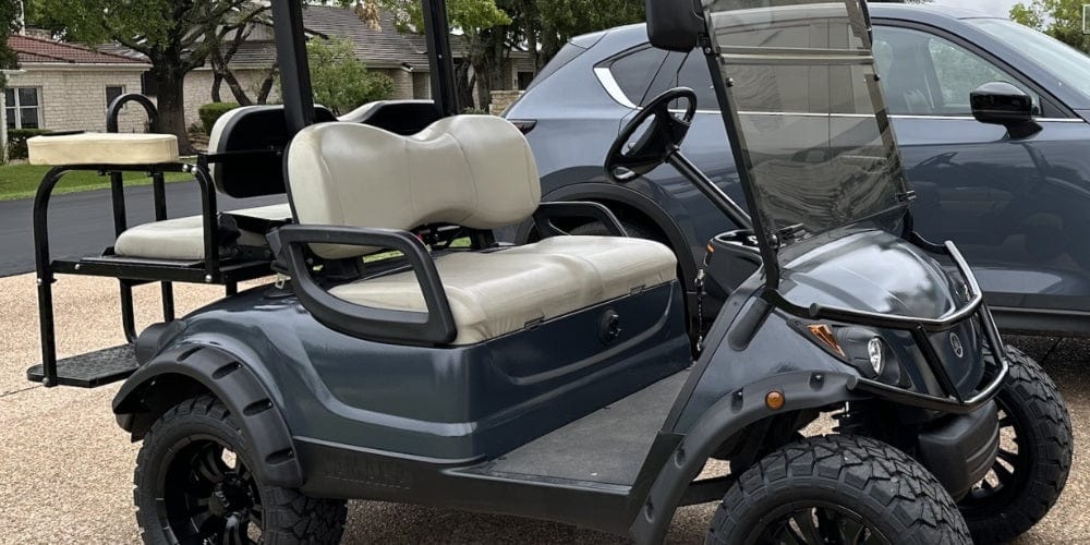 Golf cart with rear seat and armrests installed